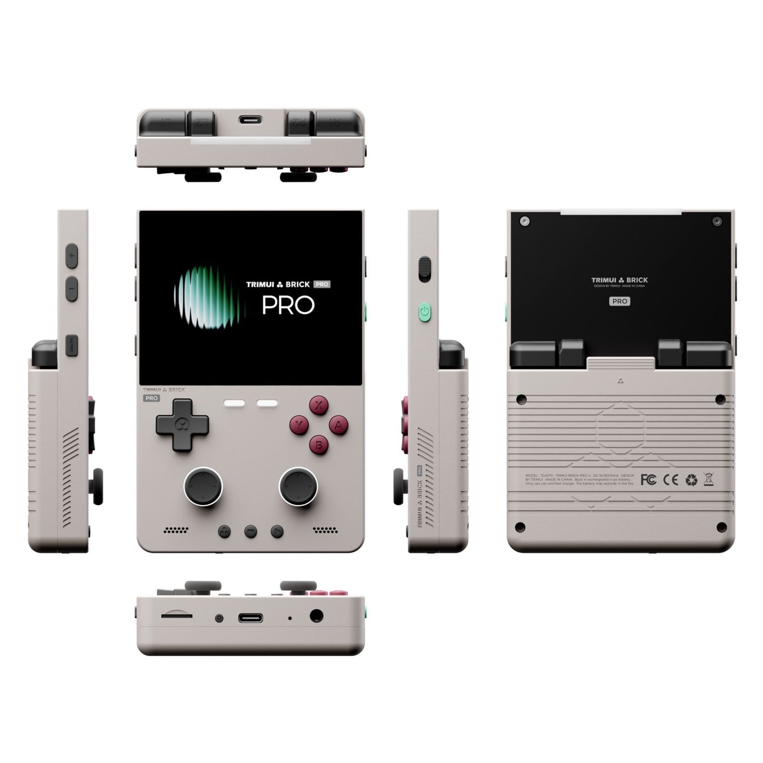 A compact handheld gaming console shown from multiple angles on a plain white background. The front view shows a black display screen with the text 'TRINKET & BRICK PRO', gray controls, and pink buttons.